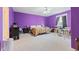 Spacious bedroom with plush carpet, bright purple walls, and a ceiling fan for added comfort at 13499 Marjac Way, Fishers, IN 46055