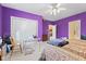 Bright bedroom featuring plush carpet, ceiling fan, and bold purple walls at 13499 Marjac Way, Fishers, IN 46055