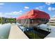 View of the covered boat on the lift at a covered boathouse on the water at 13499 Marjac Way, Fishers, IN 46055