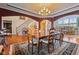 Elegant dining room boasts a chandelier, hardwood floors, and access to the staircase and living area at 13499 Marjac Way, Fishers, IN 46055