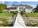 Stunning waterfront home featuring a walkway from the house to a dock and beautiful outdoor living spaces at 13499 Marjac Way, Fishers, IN 46055