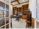 Sophisticated home office with coffered ceilings, custom built-ins, and ample natural light at 13499 Marjac Way, Fishers, IN 46055
