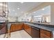 Basement kitchen features wooden cabinets, granite countertops, and an open layout to the living area at 13499 Marjac Way, Fishers, IN 46055