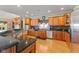 Well-lit kitchen featuring stainless steel appliances, granite countertops, and hardwood floors at 13499 Marjac Way, Fishers, IN 46055