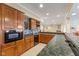 Basement kitchen with wood cabinets, a microwave, and long countertop at 13499 Marjac Way, Fishers, IN 46055