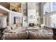 Open-concept living room with a fireplace, high ceilings, and second floor access, offering lots of natural light at 13499 Marjac Way, Fishers, IN 46055