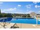 Inviting backyard pool featuring a lake backdrop and a comfortable lounge chair at 13499 Marjac Way, Fishers, IN 46055