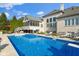Beautiful backyard featuring a large swimming pool with an attached screened-in porch at 13499 Marjac Way, Fishers, IN 46055