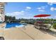 Outdoor pool features a lake view, patio furniture, and a basketball hoop at 13499 Marjac Way, Fishers, IN 46055