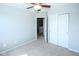 Bedroom with carpeted floor and ceiling fan featuring an open doorway and double closets at 14041 Wimbleton Way, Fishers, IN 46037