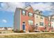 Three townhomes showing architectural details and landscaping at 14041 Wimbleton Way, Fishers, IN 46037