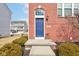 Close-up of a brick townhome entrance with a blue front door at 14041 Wimbleton Way, Fishers, IN 46037