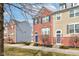 Exterior view of a brick townhome with blue shutters and a blue door at 14041 Wimbleton Way, Fishers, IN 46037