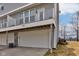 Gray townhouse showing garage and balcony with white railing at 14041 Wimbleton Way, Fishers, IN 46037