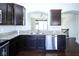 Well-lit kitchen features granite countertops, stainless steel appliances and dark wood cabinetry at 14041 Wimbleton Way, Fishers, IN 46037
