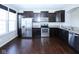 Kitchen featuring granite countertops, stainless steel appliances, and dark wood cabinets at 14041 Wimbleton Way, Fishers, IN 46037