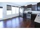 Kitchen with dark cabinets, stainless steel appliances, and hardwood floors at 14041 Wimbleton Way, Fishers, IN 46037