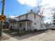 Two-story home featuring a front porch and a classic, timeless facade, on a partially sunny day at 159 E Washington St, Morgantown, IN 46160