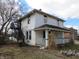 Two-story home with a classic front porch, complemented by an exterior metal staircase, and established yard at 159 E Washington St, Morgantown, IN 46160