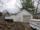 View of a detached garage, providing ample space for parking and storage, surrounded by wood at 159 E Washington St, Morgantown, IN 46160