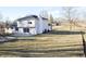 Large backyard featuring a two-story home with a stone chimney and a play area at 1634 Muessing Rd, Indianapolis, IN 46239