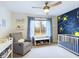 Charming Bedroom featuring a Starry Night accent wall, crib, and comfortable glider chair at 1634 Muessing Rd, Indianapolis, IN 46239
