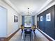 Elegant dining room with modern lighting, a wooden table, and stylish wall paneling at 1634 Muessing Rd, Indianapolis, IN 46239