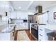 Bright kitchen with stainless steel appliances, granite countertops, and white cabinets at 1634 Muessing Rd, Indianapolis, IN 46239