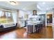 Modern kitchen with stainless appliances, white cabinetry, an island, and bench seating at 1634 Muessing Rd, Indianapolis, IN 46239