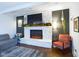 Cozy living room with a white stone fireplace, a mounted TV, and a comfortable seating area at 1634 Muessing Rd, Indianapolis, IN 46239