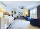 Bright living room featuring a white piano, comfortable seating, and a ceiling fan at 1634 Muessing Rd, Indianapolis, IN 46239