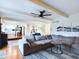Bright living room with wood floors and a sectional couch, with view to kitchen at 1634 Muessing Rd, Indianapolis, IN 46239