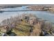 Stunning aerial view of lakefront house surrounded by mature trees, with a frozen lake backdrop at 18 Point Ln, Arcadia, IN 46030