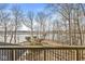 Back deck overlooking lawn leading to a frozen lake, with space for outdoor seating at 18 Point Ln, Arcadia, IN 46030