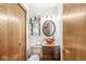 Small powder room featuring a vessel sink and wood cabinetry at 18 Point Ln, Arcadia, IN 46030