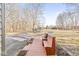 Inviting driveway and front entrance with a wooden bench overlooking the lush yard at 18 Point Ln, Arcadia, IN 46030
