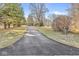Long driveway leading up to a home surrounded by mature trees and a sprawling lawn at 18 Point Ln, Arcadia, IN 46030