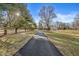 Long driveway leading up to a home surrounded by mature trees and a sprawling lawn at 18 Point Ln, Arcadia, IN 46030