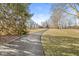 Long driveway leading up to a home surrounded by mature trees and a sprawling lawn at 18 Point Ln, Arcadia, IN 46030