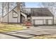 Front of the home with an attached two car garage, with a large driveway and landscaping at 18 Point Ln, Arcadia, IN 46030