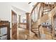 Open-concept living room with wood floors, spiral staircase, and modern fireplace at 18 Point Ln, Arcadia, IN 46030