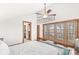 Bright main bedroom features vaulted ceilings, a ceiling fan, doors to a deck, and ensuite access at 18 Point Ln, Arcadia, IN 46030
