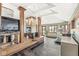 Recreation room with wooden pillars, brick floors, gym equipment, and a fireplace at 18 Point Ln, Arcadia, IN 46030