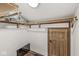 Attic storage features wooden racks, a utility door, and a bare bulb ceiling light at 18 Point Ln, Arcadia, IN 46030