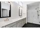 Elegant bathroom featuring double sinks, quartz countertops, and a glass-enclosed shower with white tile at 1935 Ponsonby Dr, Westfield, IN 46074