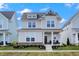 Charming two-story home featuring a landscaped yard, covered entry, and a classic architectural design at 1935 Ponsonby Dr, Westfield, IN 46074