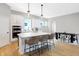 Bright kitchen with white cabinetry, stainless steel appliances, and island seating flowing into a dining area at 1935 Ponsonby Dr, Westfield, IN 46074