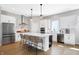 Modern kitchen with white cabinetry, stainless steel appliances, and a center island with seating at 1935 Ponsonby Dr, Westfield, IN 46074