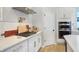 Well-appointed kitchen with white cabinets, stainless steel appliances, and a stylish gas range at 1935 Ponsonby Dr, Westfield, IN 46074