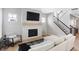 Bright living room featuring a modern fireplace and staircase, creating a cozy yet elegant atmosphere at 1935 Ponsonby Dr, Westfield, IN 46074